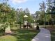 Community playground with swings, slides, and green space for children to play at 4116 Knollpoint Dr, Wesley Chapel, FL 33544