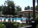 Community pool with chairs and tables available to residents at 4116 Knollpoint Dr, Wesley Chapel, FL 33544