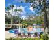 Community splash pad offering a fun, colorful water play area with lounge chairs at 4116 Knollpoint Dr, Wesley Chapel, FL 33544