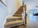Staircase with wood and carpet connects the first and second floor at 4116 Knollpoint Dr, Wesley Chapel, FL 33544