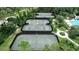 Aerial view of community tennis courts surrounded by trees at 4116 Knollpoint Dr, Wesley Chapel, FL 33544