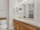 Bright bathroom features a large mirror, a single sink vanity, and a shower with a striped curtain at 4901 Windingbrook Trl, Wesley Chapel, FL 33544