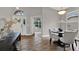 Elegant dining room with hardwood floors, chandelier, and a table set for four at 4901 Windingbrook Trl, Wesley Chapel, FL 33544