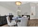 Well-lit dining space featuring hardwood floors and a dark wood dining table with seating for four at 4901 Windingbrook Trl, Wesley Chapel, FL 33544