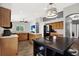 Bright kitchen with stainless steel appliances, wood cabinets, breakfast bar, and wood-look tile flooring at 4901 Windingbrook Trl, Wesley Chapel, FL 33544