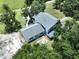 Aerial view of a home featuring lush landscaping, mature trees, and a well-maintained roof at 5007 Booth Rd, Plant City, FL 33565