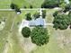 Aerial view of a home, nestled among greenery and surrounded by sprawling fields at 5007 Booth Rd, Plant City, FL 33565