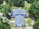 Aerial view of a home with a gray roof, showcasing the spacious lot and lush greenery at 5007 Booth Rd, Plant City, FL 33565
