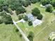 Expansive aerial view of a charming home surrounded by lush greenery and a well-manicured lawn at 5007 Booth Rd, Plant City, FL 33565