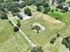 Expansive property with a pond, surrounded by lush greenery and scattered trees, offering a serene setting at 5007 Booth Rd, Plant City, FL 33565