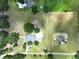 Aerial view of a home on a large lot, featuring lush greenery and a serene pond at 5007 Booth Rd, Plant City, FL 33565