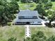 Aerial view of a traditional home with a inviting porch and lush, green landscaping at 5007 Booth Rd, Plant City, FL 33565