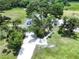 Aerial view of a charming house surrounded by trees and a beautifully landscaped yard at 5007 Booth Rd, Plant City, FL 33565