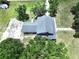 Aerial view of a home with a gray roof, surrounded by lush trees and green lawns at 5007 Booth Rd, Plant City, FL 33565