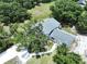 Aerial view of a well-maintained home featuring lush landscaping, mature trees, and a stone walkway at 5007 Booth Rd, Plant City, FL 33565
