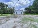 Spacious backyard, bordered with mature trees provides shade and privacy at 5007 Booth Rd, Plant City, FL 33565