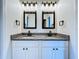 A stylish bathroom vanity with dual sinks, granite countertops, and square framed mirrors at 5007 Booth Rd, Plant City, FL 33565