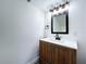 Bathroom vanity featuring a wood cabinet, light countertop, stylish mirror, and modern faucet at 5007 Booth Rd, Plant City, FL 33565
