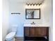 Modern bathroom vanity with dark wood cabinets, white countertop and rustic light fixture at 5007 Booth Rd, Plant City, FL 33565