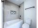 A contemporary bathroom featuring sleek white subway tile, geometric floor and a soaking tub at 5007 Booth Rd, Plant City, FL 33565