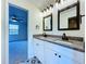Modern bathroom showcasing dual sinks, granite countertops, and custom flooring at 5007 Booth Rd, Plant City, FL 33565