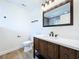 Renovated bathroom showcases a dark wood vanity, bright quartz countertop, and stylish fixtures at 5007 Booth Rd, Plant City, FL 33565