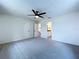 Carpeted bedroom with neutral walls, ceiling fan, and access to an ensuite bathroom at 5007 Booth Rd, Plant City, FL 33565
