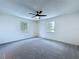 Large carpeted bedroom with two windows offering natural light at 5007 Booth Rd, Plant City, FL 33565
