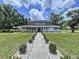 Inviting home with a well-manicured lawn, mature trees, and a charming walkway, creating a welcoming ambiance at 5007 Booth Rd, Plant City, FL 33565