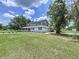 Beautiful two-story home features a sprawling lawn and a charming wraparound porch at 5007 Booth Rd, Plant City, FL 33565