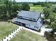 Charming two-story home with a covered front porch, landscaped walkway, and lush surrounding greenery at 5007 Booth Rd, Plant City, FL 33565