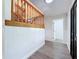 Bright foyer featuring wood-look floors, paneled walls, and a staircase with wooden banister and railing at 5007 Booth Rd, Plant City, FL 33565