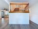 Inviting foyer with wood-look floors, paneled wall and wooden staircase adds charm to this lovely home at 5007 Booth Rd, Plant City, FL 33565