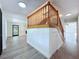 Bright foyer features wood staircase, beadboard accents, and access to the living spaces at 5007 Booth Rd, Plant City, FL 33565