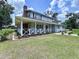 Inviting front porch with decorative railings, landscaping, and a warm, welcoming aesthetic at 5007 Booth Rd, Plant City, FL 33565