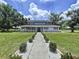 Charming two-story home featuring a welcoming porch and well-manicured landscaping at 5007 Booth Rd, Plant City, FL 33565