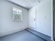 Clean garage with painted floor, window, door and ample space at 5007 Booth Rd, Plant City, FL 33565