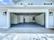 Clean, well-lit garage with epoxy flooring, featuring a modern design and ample space for parking and storage at 5007 Booth Rd, Plant City, FL 33565