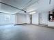 View of the garage with painted floor, equipped with a window, a door and a utility closet at 5007 Booth Rd, Plant City, FL 33565