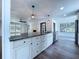 Kitchen island with granite countertops, white cabinets, and stainless steel appliances at 5007 Booth Rd, Plant City, FL 33565