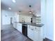 Bright kitchen featuring granite countertops, white cabinets, and black appliances at 5007 Booth Rd, Plant City, FL 33565
