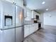 Kitchen featuring stainless steel refrigerator, white cabinets, and granite countertops at 5007 Booth Rd, Plant City, FL 33565