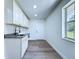 Bright laundry room with sink and shaker style cabinets at 5007 Booth Rd, Plant City, FL 33565