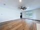 Spacious living room with wood floors, a modern ceiling fan, and large windows at 5007 Booth Rd, Plant City, FL 33565