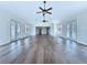 Bright, open living room features beautiful floors, neutral walls, ceiling fans and lots of natural light at 5007 Booth Rd, Plant City, FL 33565
