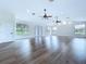 Spacious living room with wood floors, large windows, and ceiling fans at 5007 Booth Rd, Plant City, FL 33565
