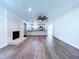 Open-concept living room featuring fireplace and views into the modern eat-in kitchen with stainless appliances at 5007 Booth Rd, Plant City, FL 33565