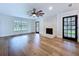 Comfortable living room with stylish fireplace, hardwood floors, and abundant natural light for a welcoming ambiance at 5007 Booth Rd, Plant City, FL 33565