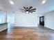 Large living room featuring hardwood floors, ceiling fan, and open layout leading into other areas of the home at 5007 Booth Rd, Plant City, FL 33565