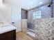 Modern shower with designer tile, a rainfall showerhead, and stone pebble flooring at 5007 Booth Rd, Plant City, FL 33565